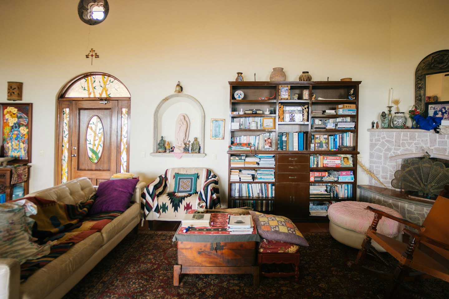 A living room with a sofa, fireplace, and bookshelves.